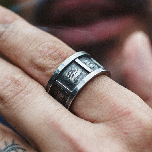 Ring made in silver. Textured in the background with clean columns up front..